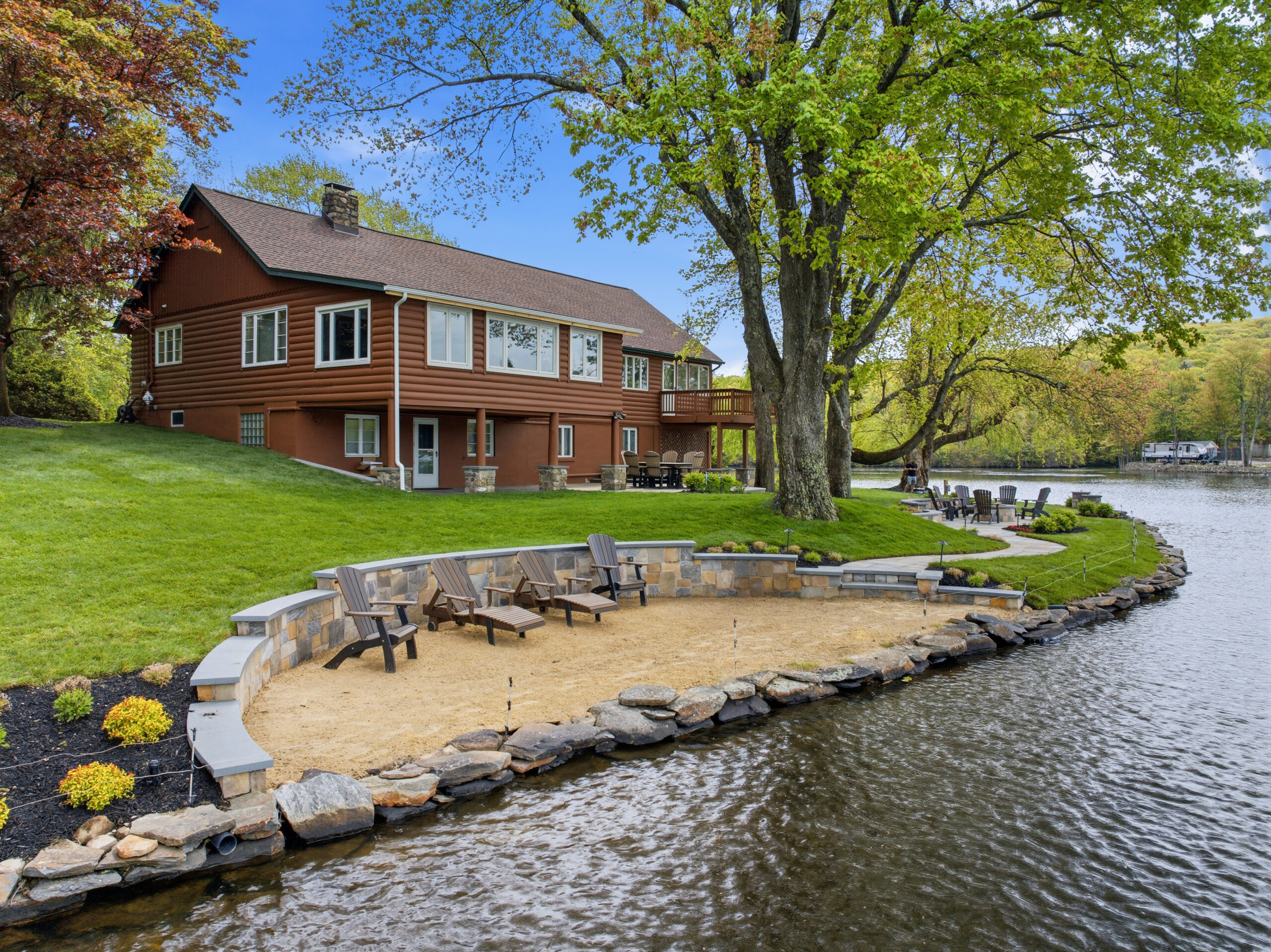 Sandy beach area with Adirondack chairs